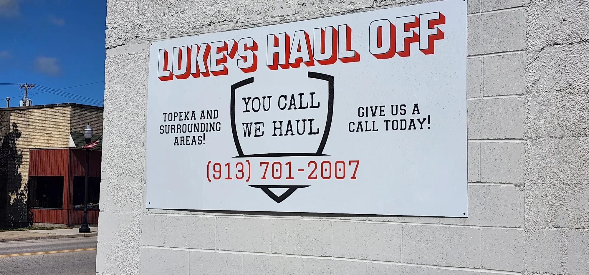 Luke's Haul Off sign on the shop wall reading You Call We Haul